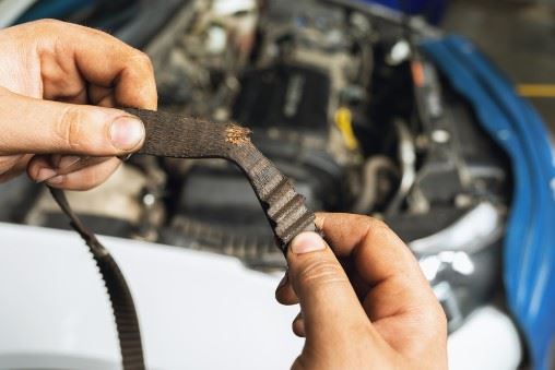 man holding a defective car part