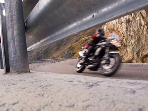 motorcyclist speeding around a corner on highway