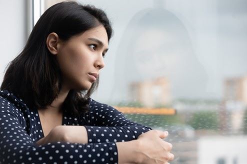 sad woman looking out window