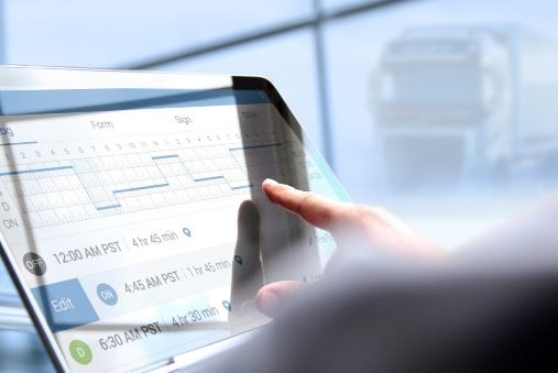 truck driver filling out an electronic logbook