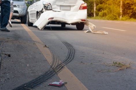 two cars on the side of the road after crash