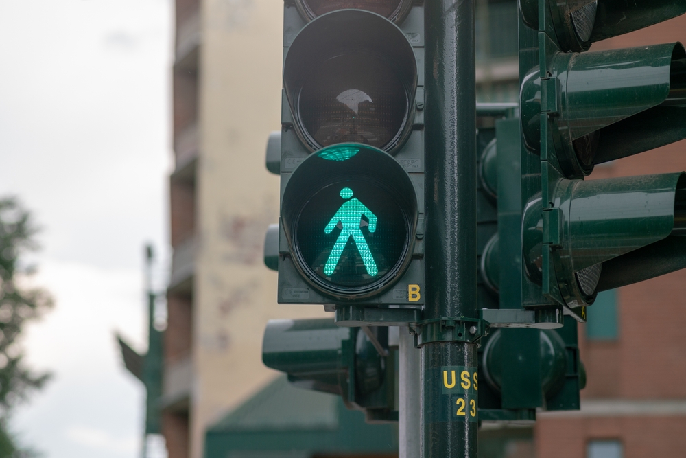 A green pedestrian walk signal at a city crosswalk in Reno, Nevada.